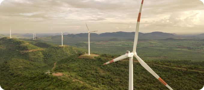 Wind turbines across green hills